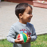 Child smiling with ball