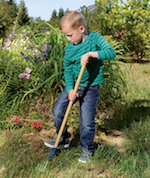 Boy Digging in Garden